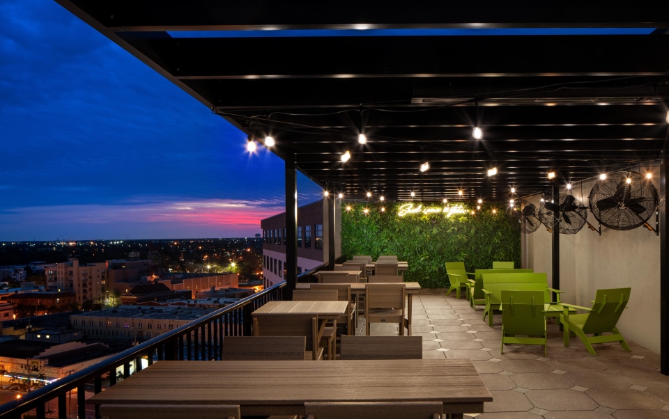 A rooftop patio with tables and chairs