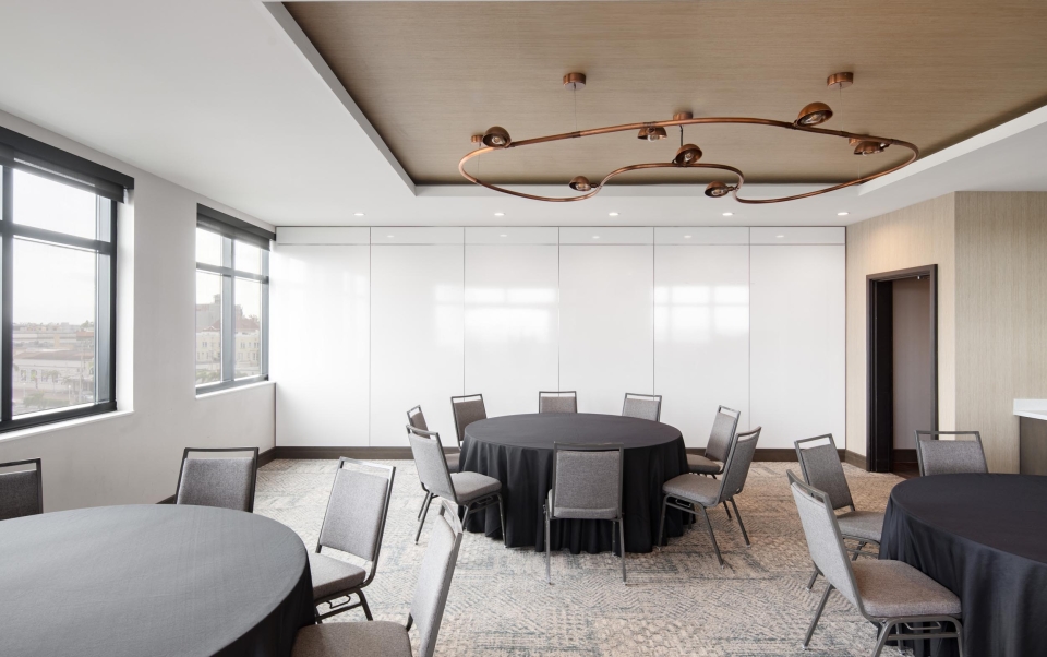 A meeting room with a round table and chairs